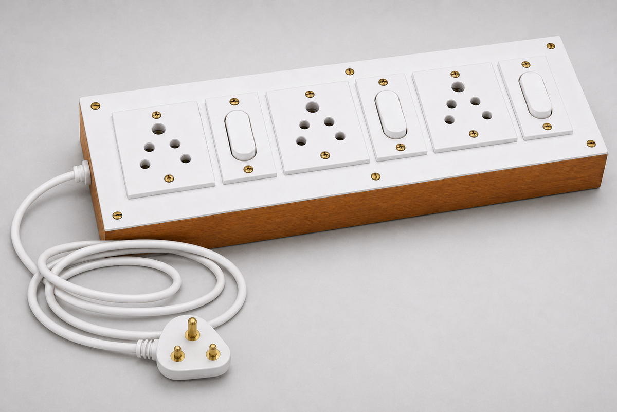 White and wooden extension board with three sockets and switches